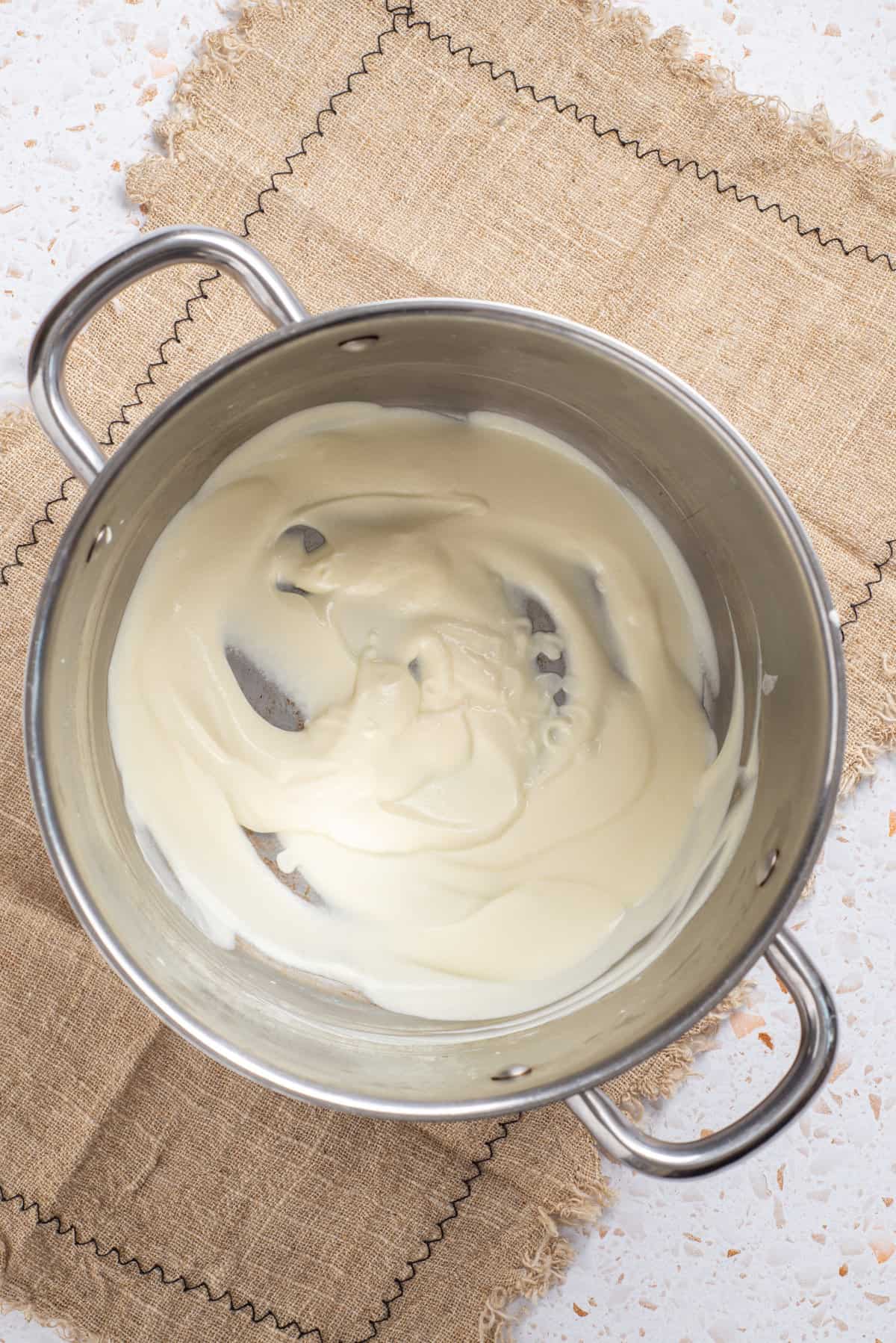 An image of melted cream cheese in a saucepan.