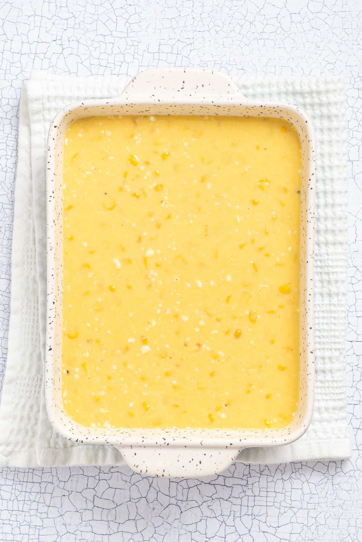 An overhead image of the corn mixture transferred to a casserole baking tray.