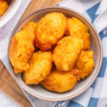 An overhead image of crispy corn nuggets in a bowl.