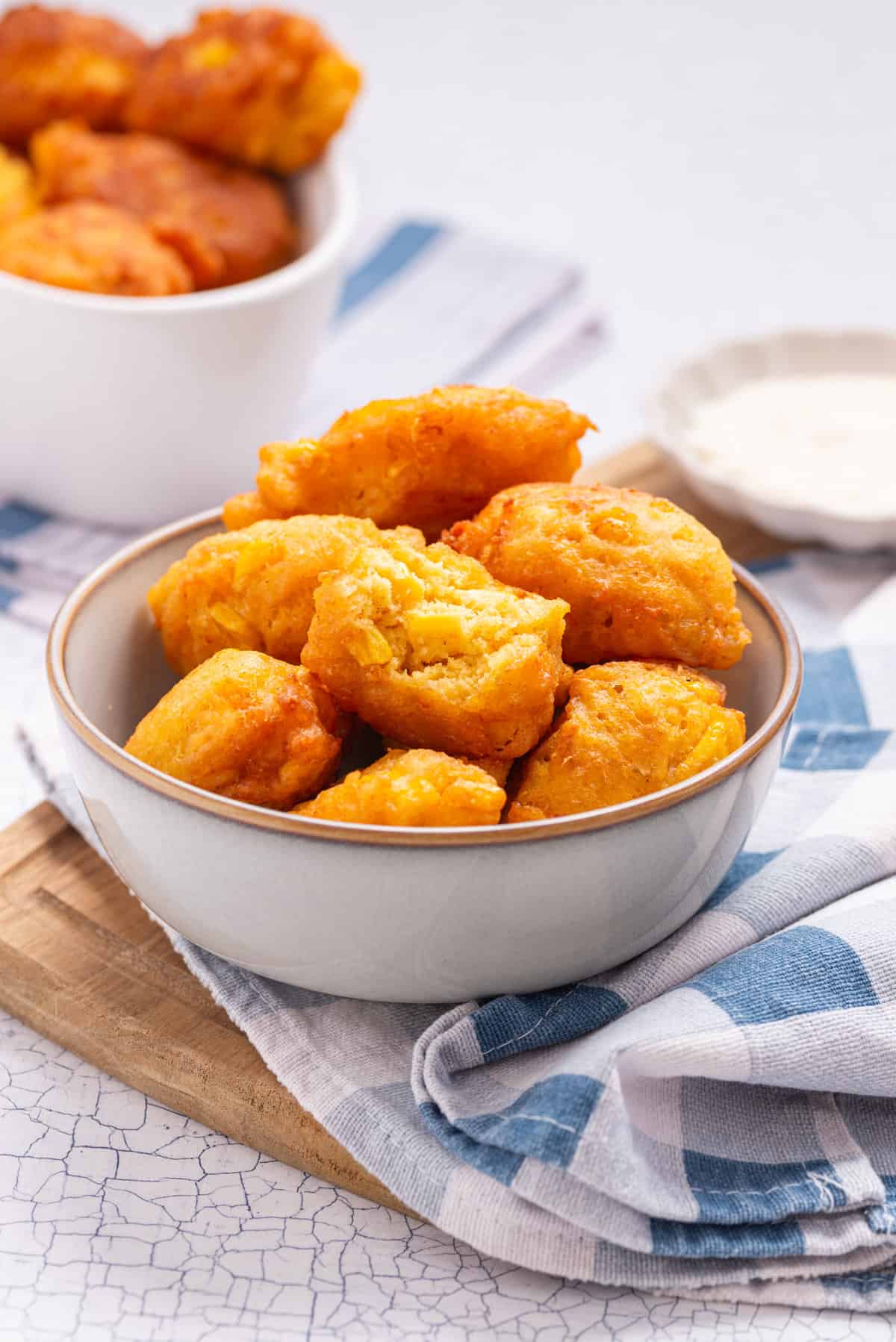 An image of fried corn nuggets in a bowl.
