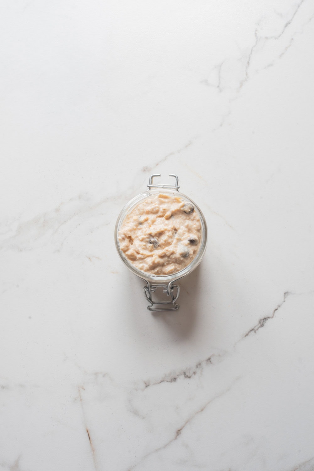 Overhead image of cottage cheese cookie dough overnight oats in a jar.