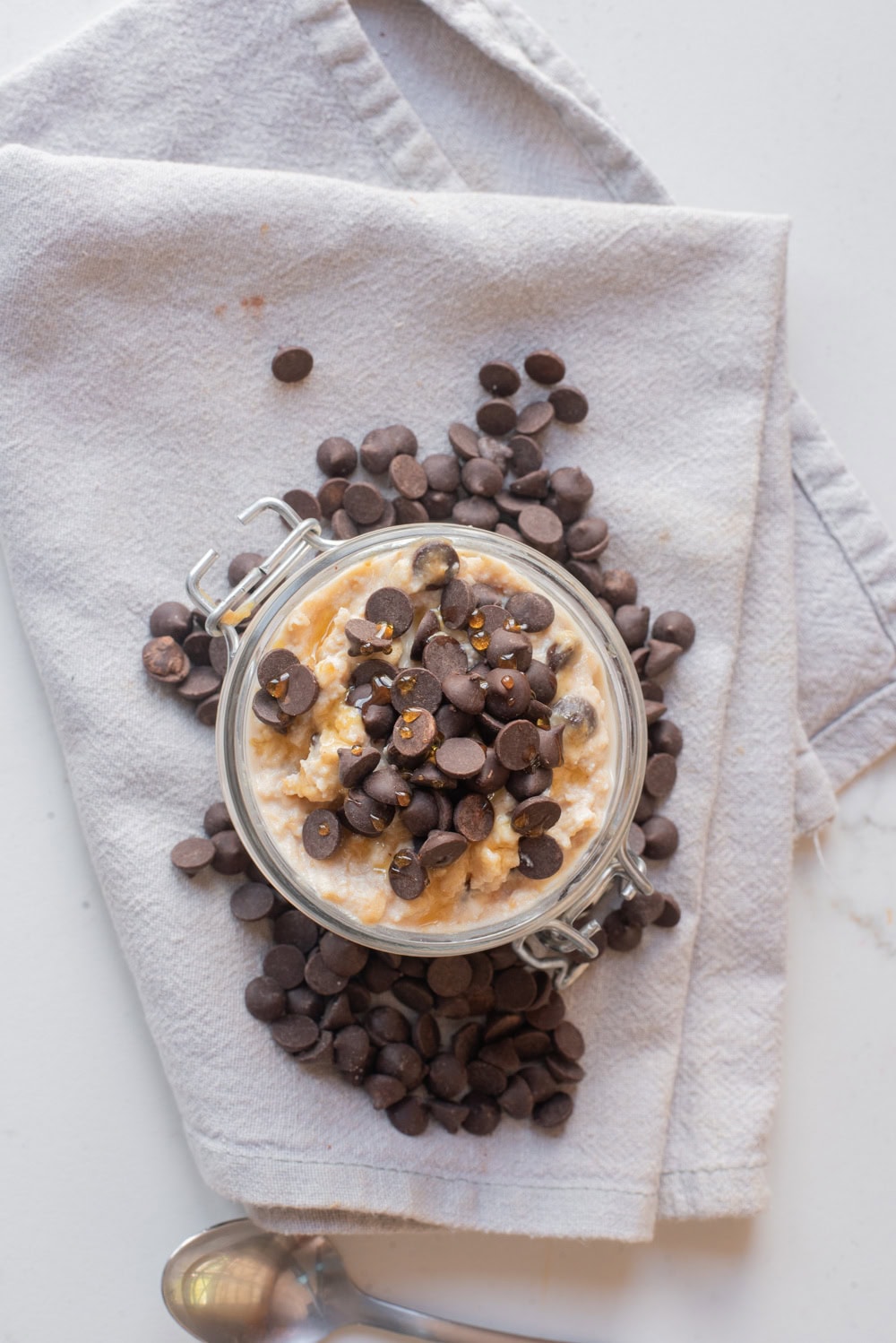 Cottage cheese cookie dough overnight oats in a jar topped with mini chocolate chips.