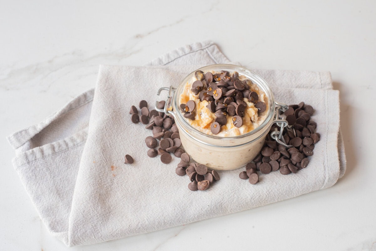 Cottage cheese cookie dough overnight oats topped with mini chocolate chips in a jar.