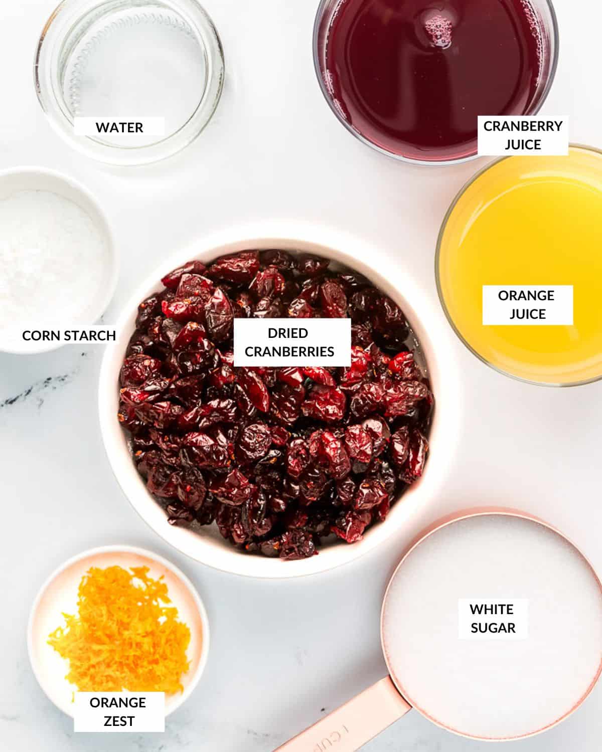 Overhead view of ingredients for cranberry sauce with dried cranberries, check recipe card for details 