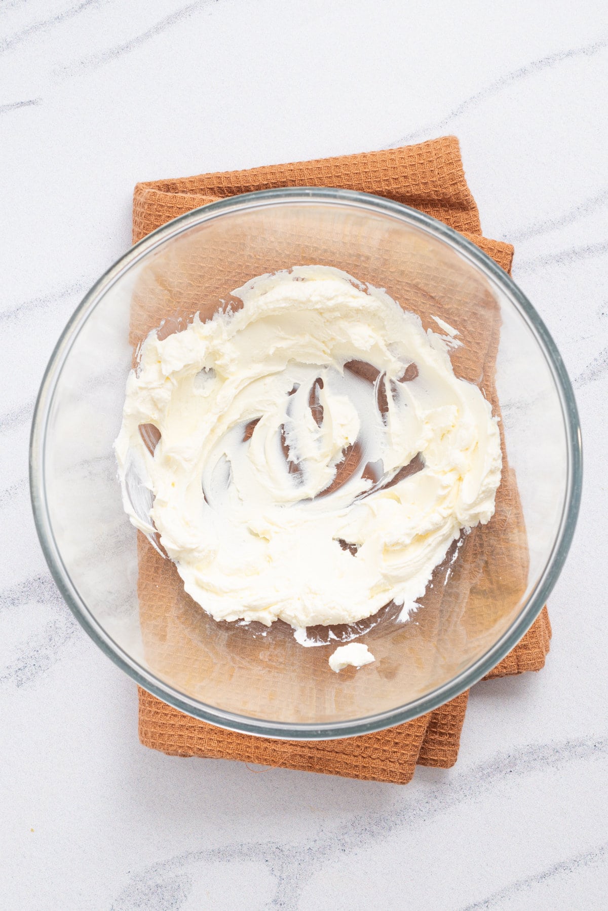 An overhead image of whipped cream cheese in a baking dish.