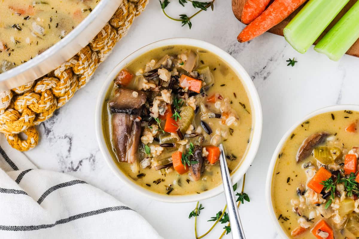 An overhead image of creamy wild rice soup in a bowl.