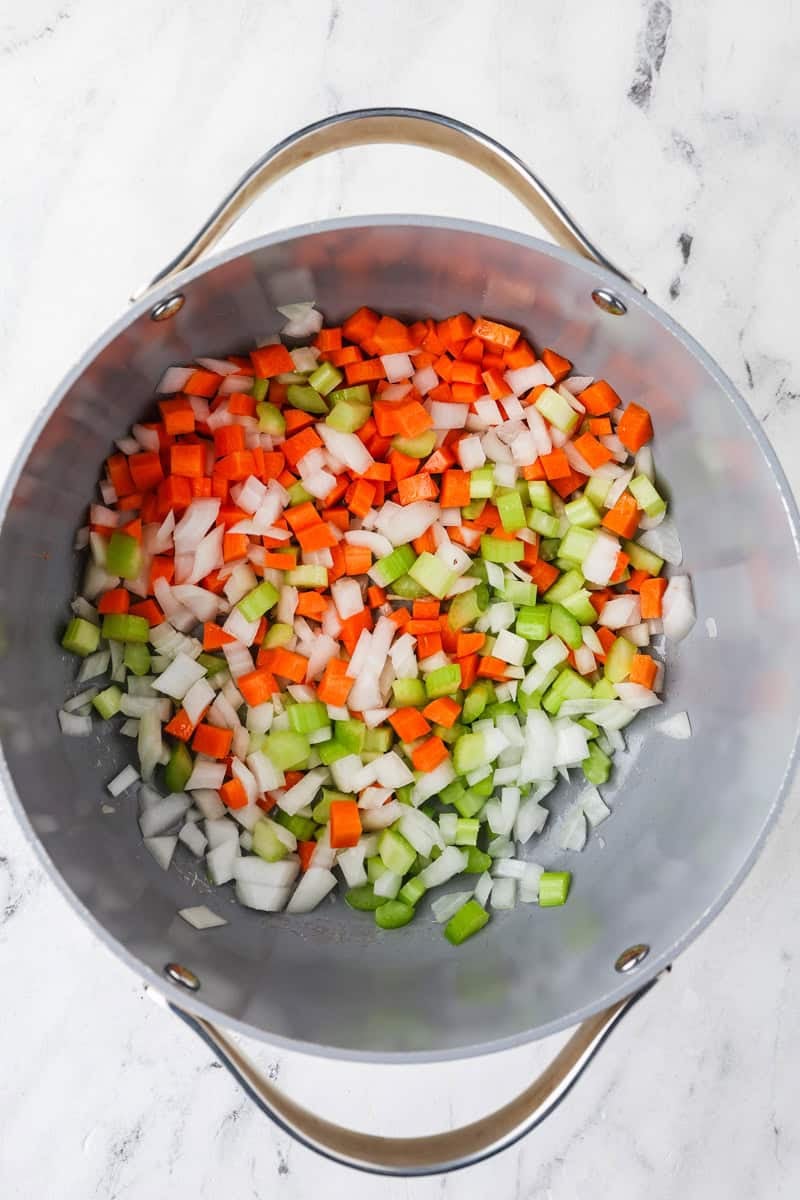 An overhead image of sauteing the veggies in a pot.