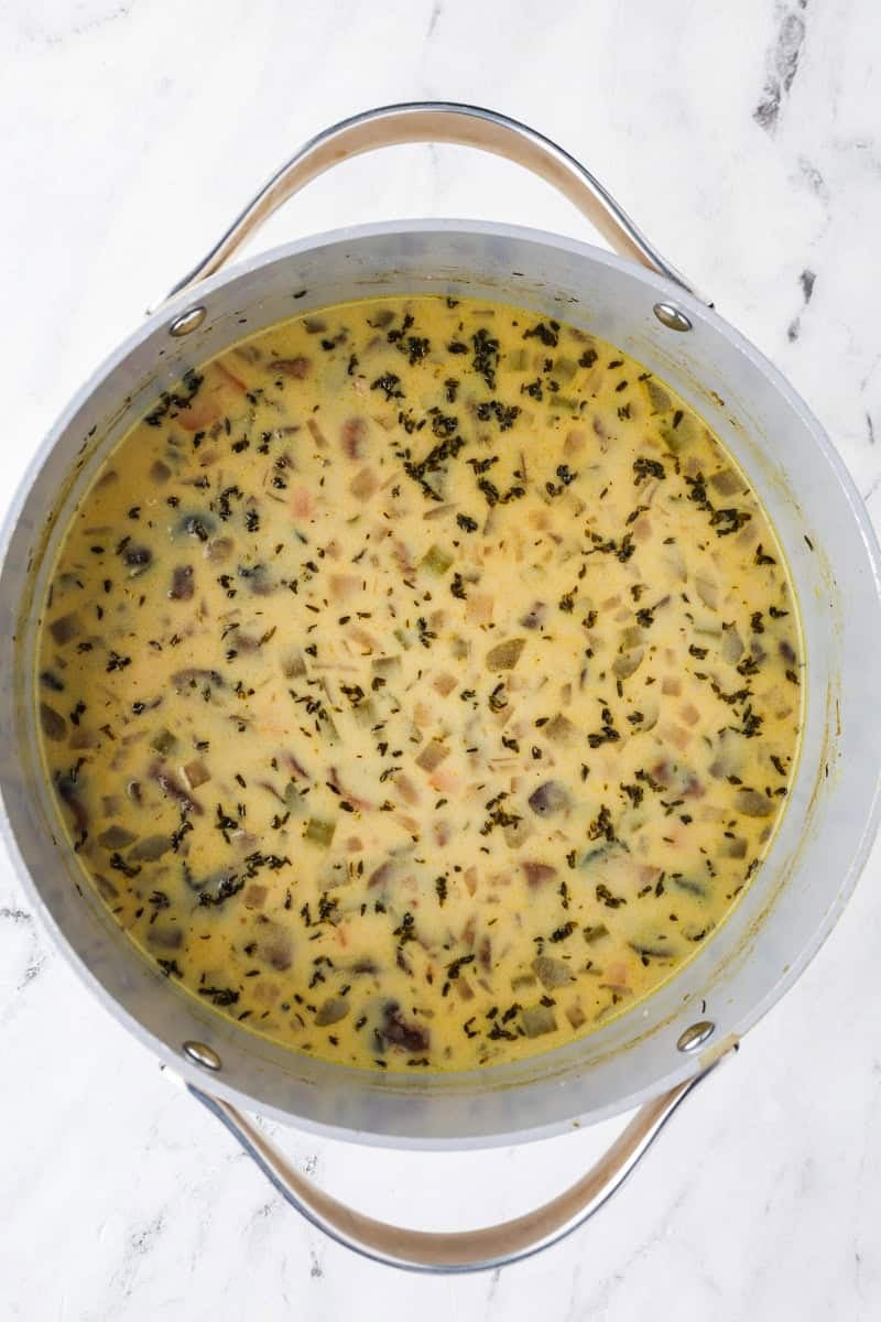 An overhead image of adding the roux to the pot.
