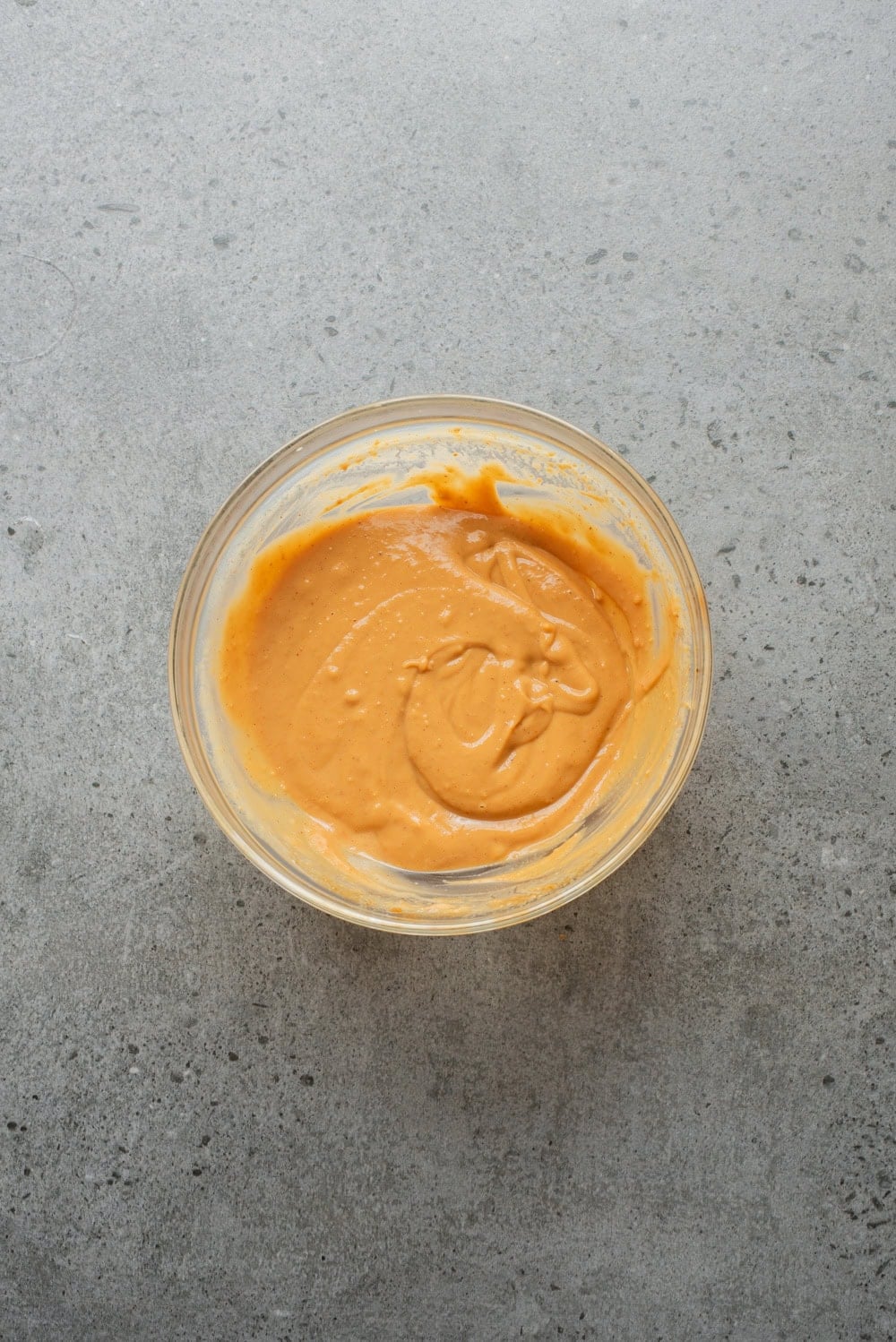 An overhead image of whisking the sauce together.