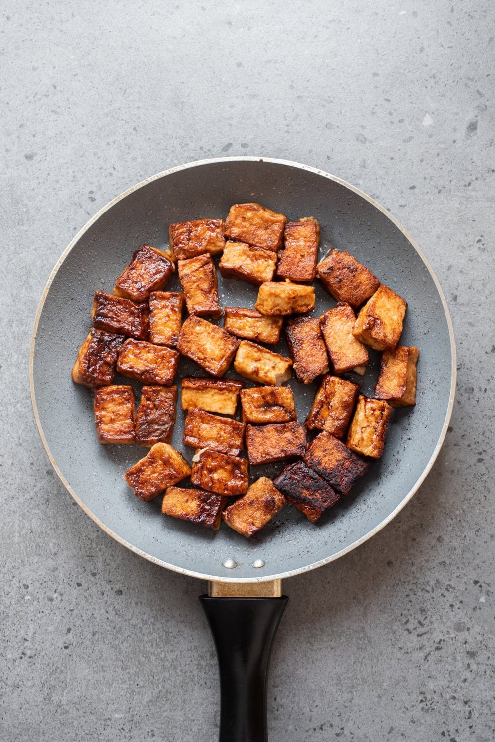 An overhead image of crispy tofu in a pan.