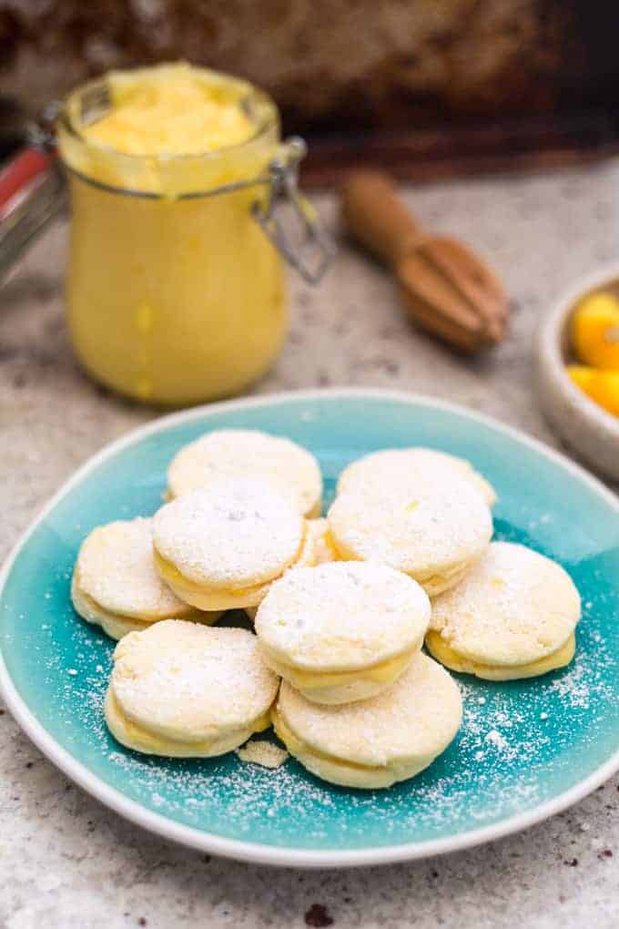 Close up of alfajores with lemon curd jar in the background