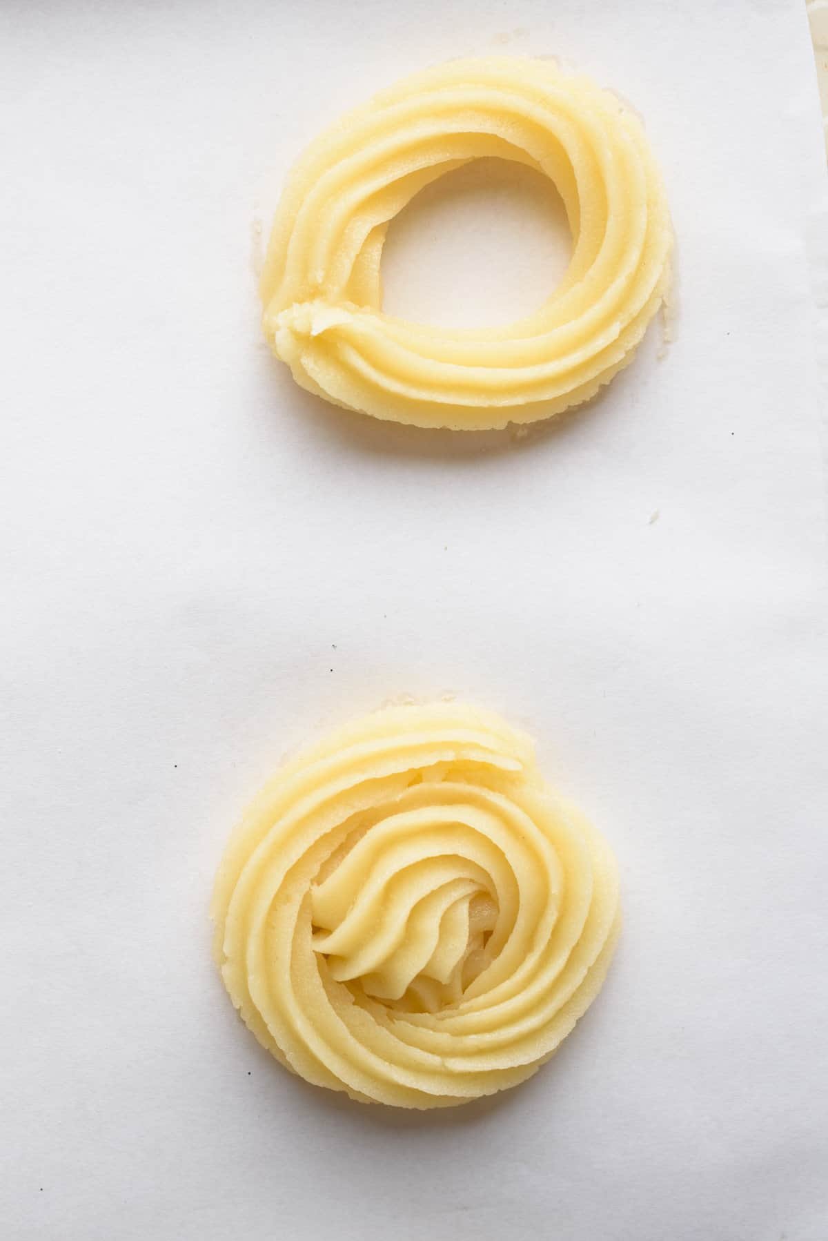 Overhead view showing two step process to pipe the outer ring (above) and inner ring (below). Before baking.,