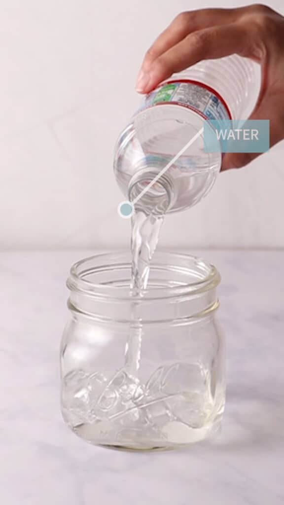 Adding water to a glass jar.