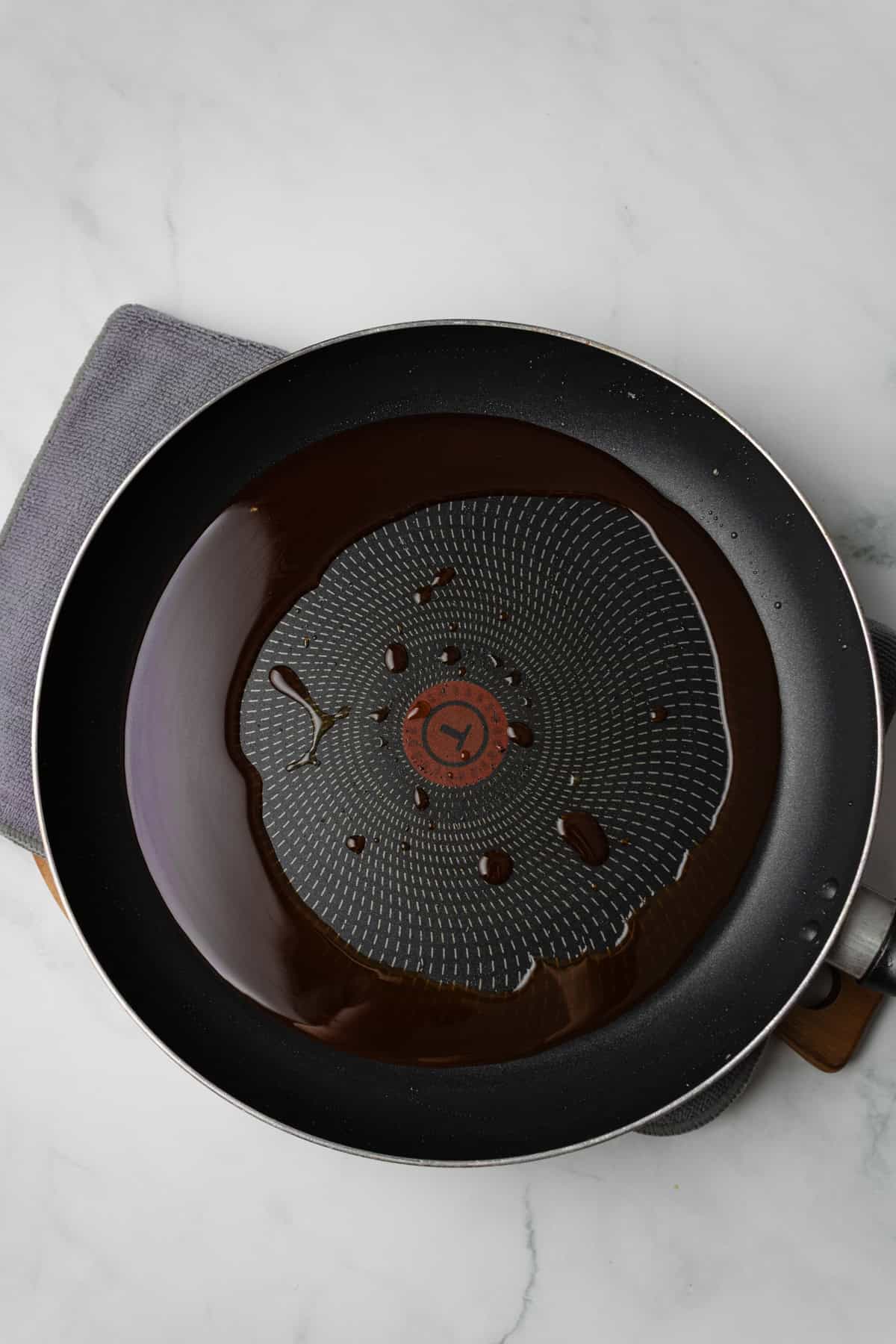 An overhead image of adding sauce to the skillet.