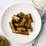 An overhead image of eggplant stir fry served on a plate.
