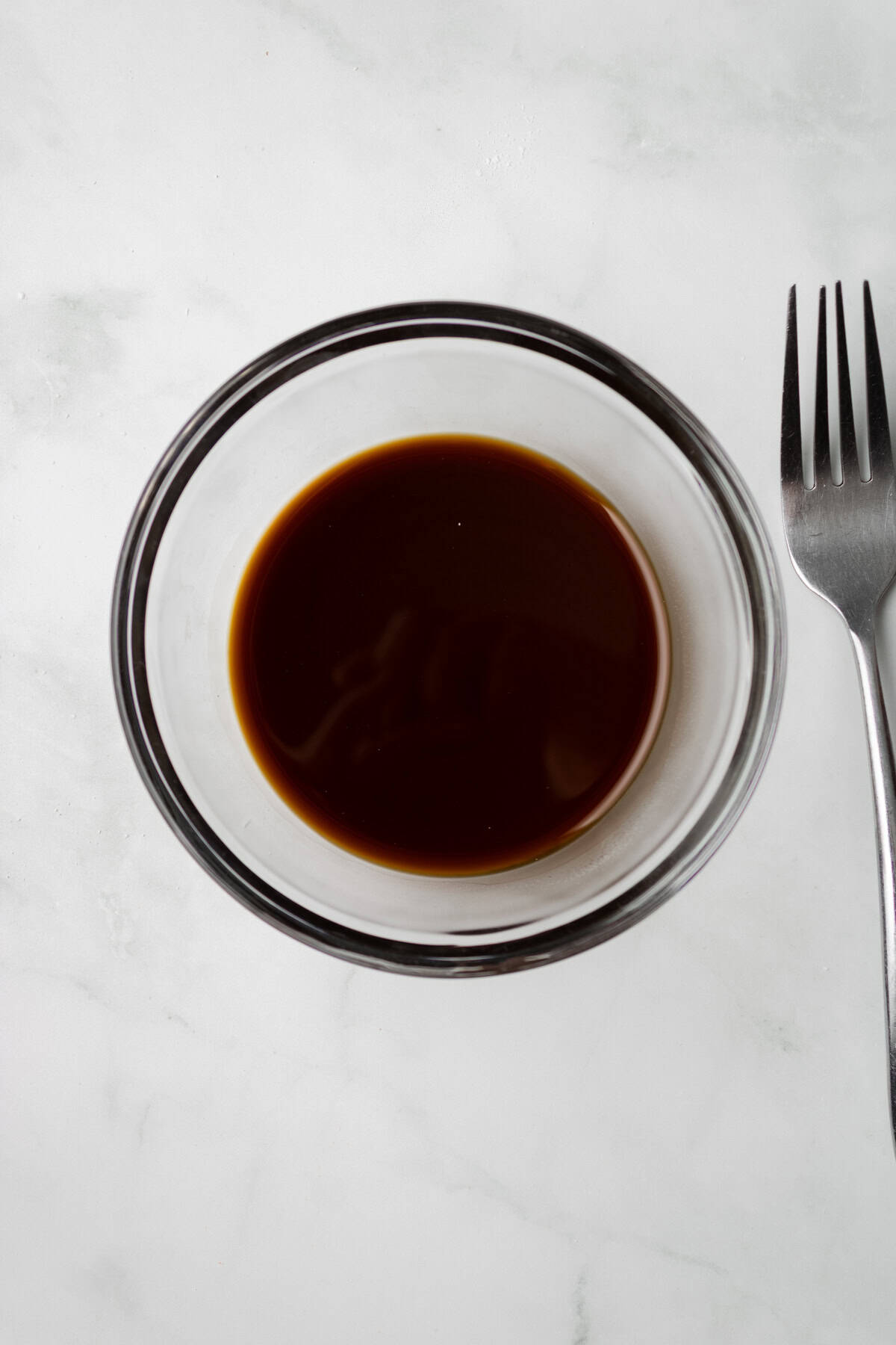 An overhead image of whisking the soy sauce together in a bowl.