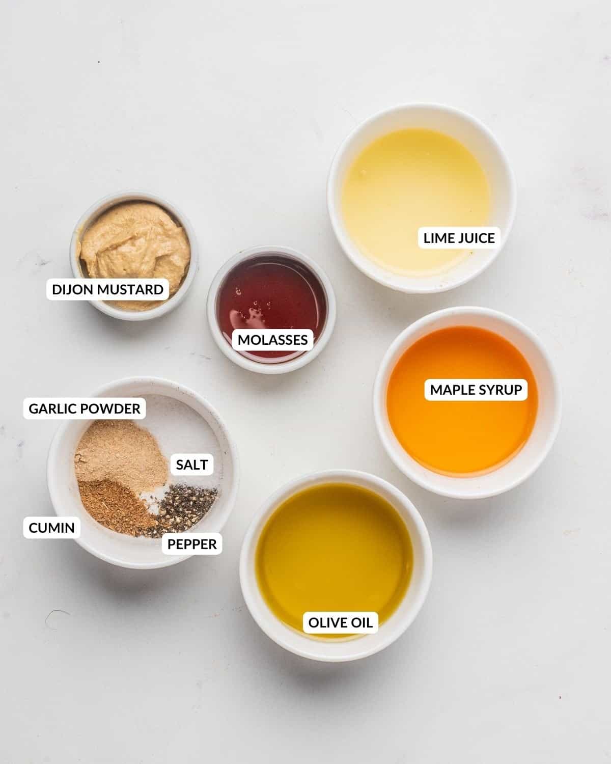 An image of the dressing ingredients in separate bowls with labels.
