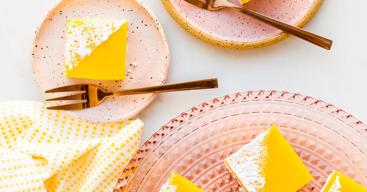 Close up of easy lemon bars on a pink plate with forks.