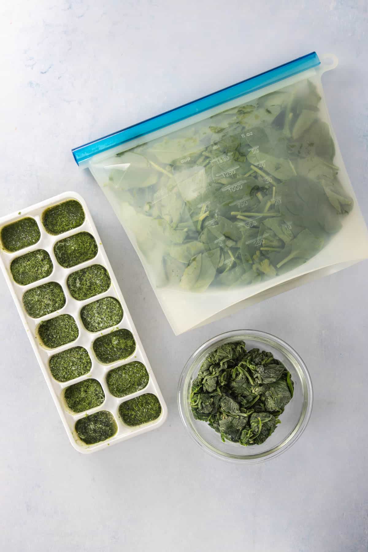 Spinach frozen three ways: pureed cubes, bag of fresh leaves, blanched spinach (clockwise) 