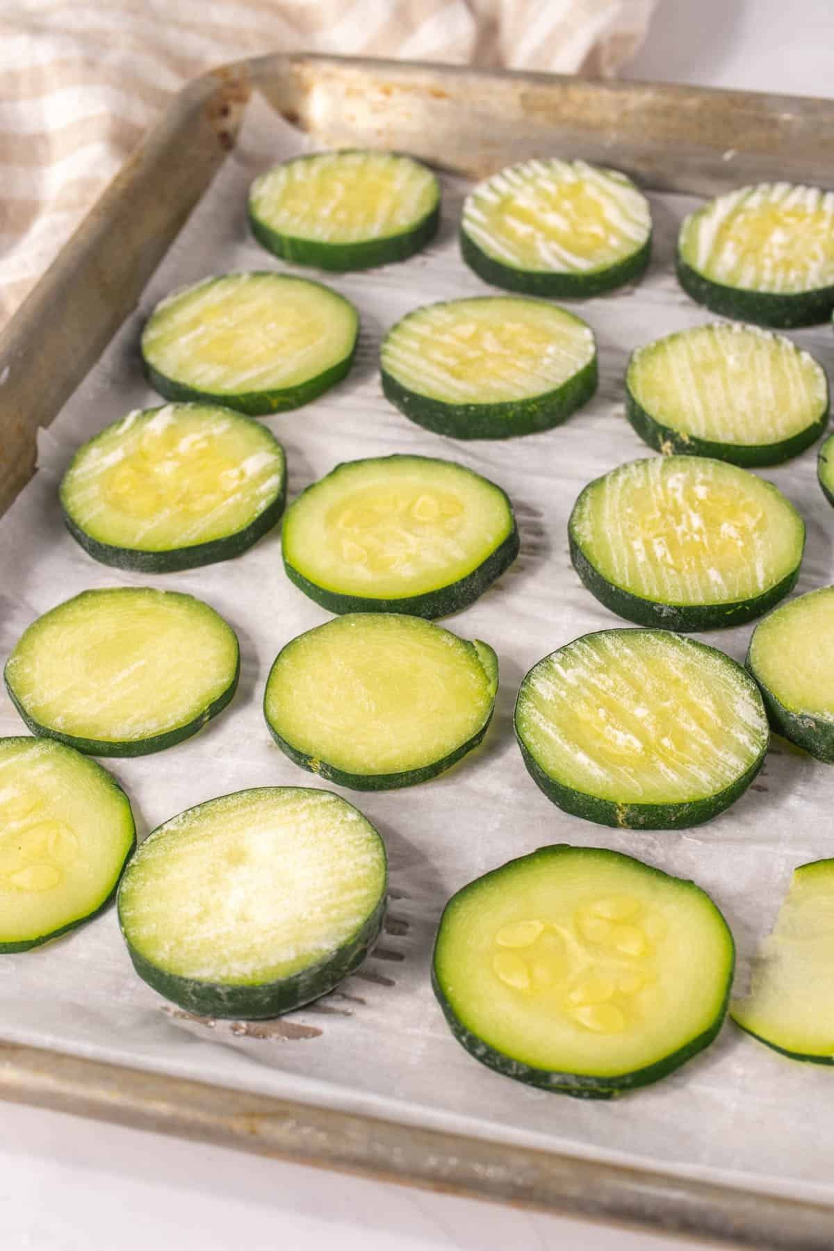 Baking sheet with frozen zucchini slices 