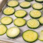 Close up of frozen zucchini slices on baking sheet