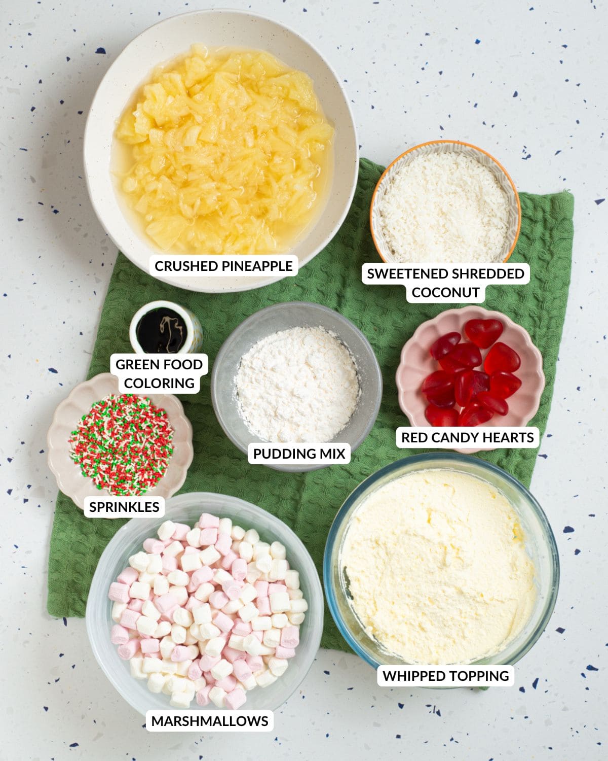 Ingredients for Grinch fluff arranged in a marble surface.