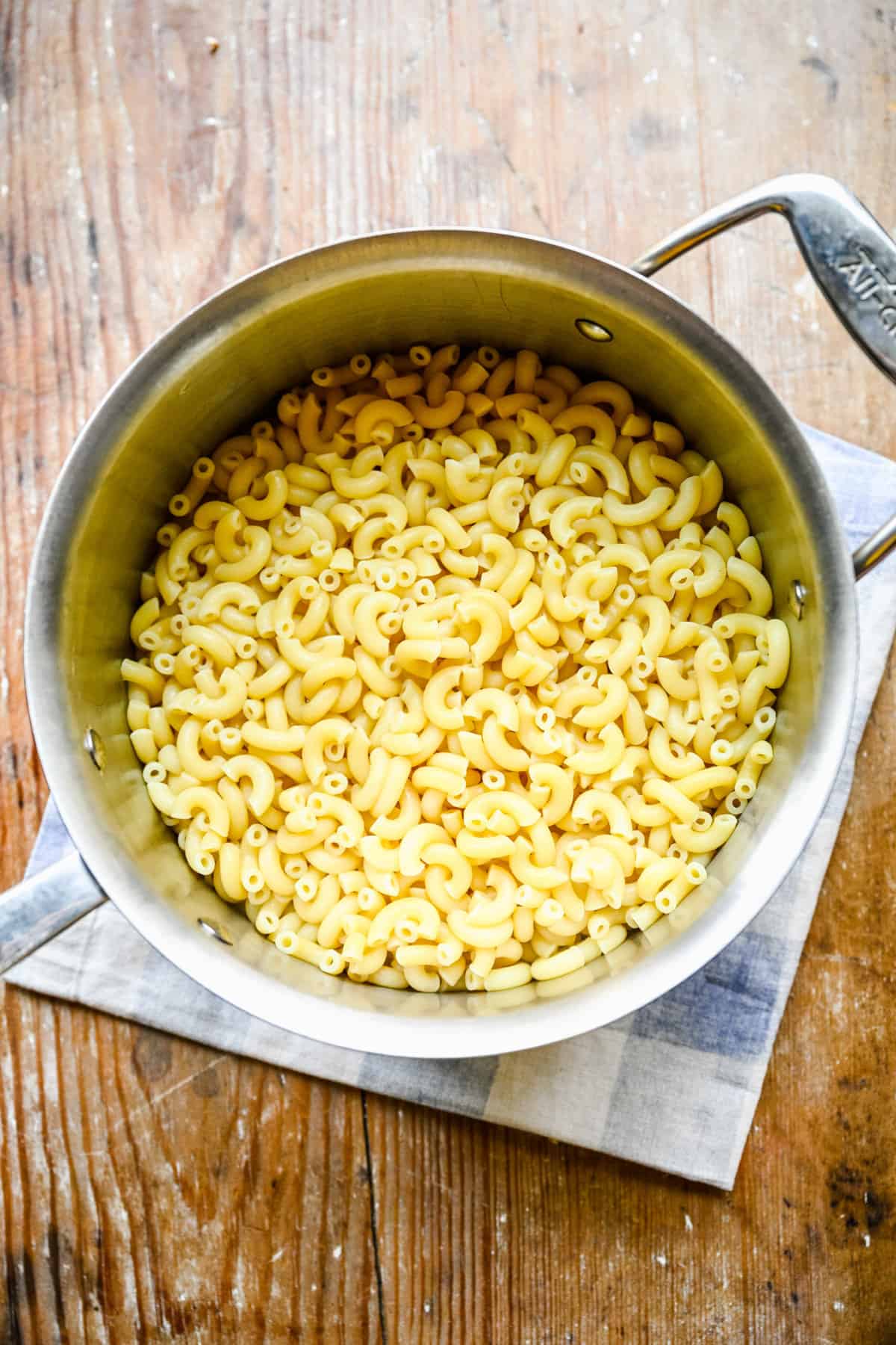 Overhead view of cooked macaroni on a large pot. 