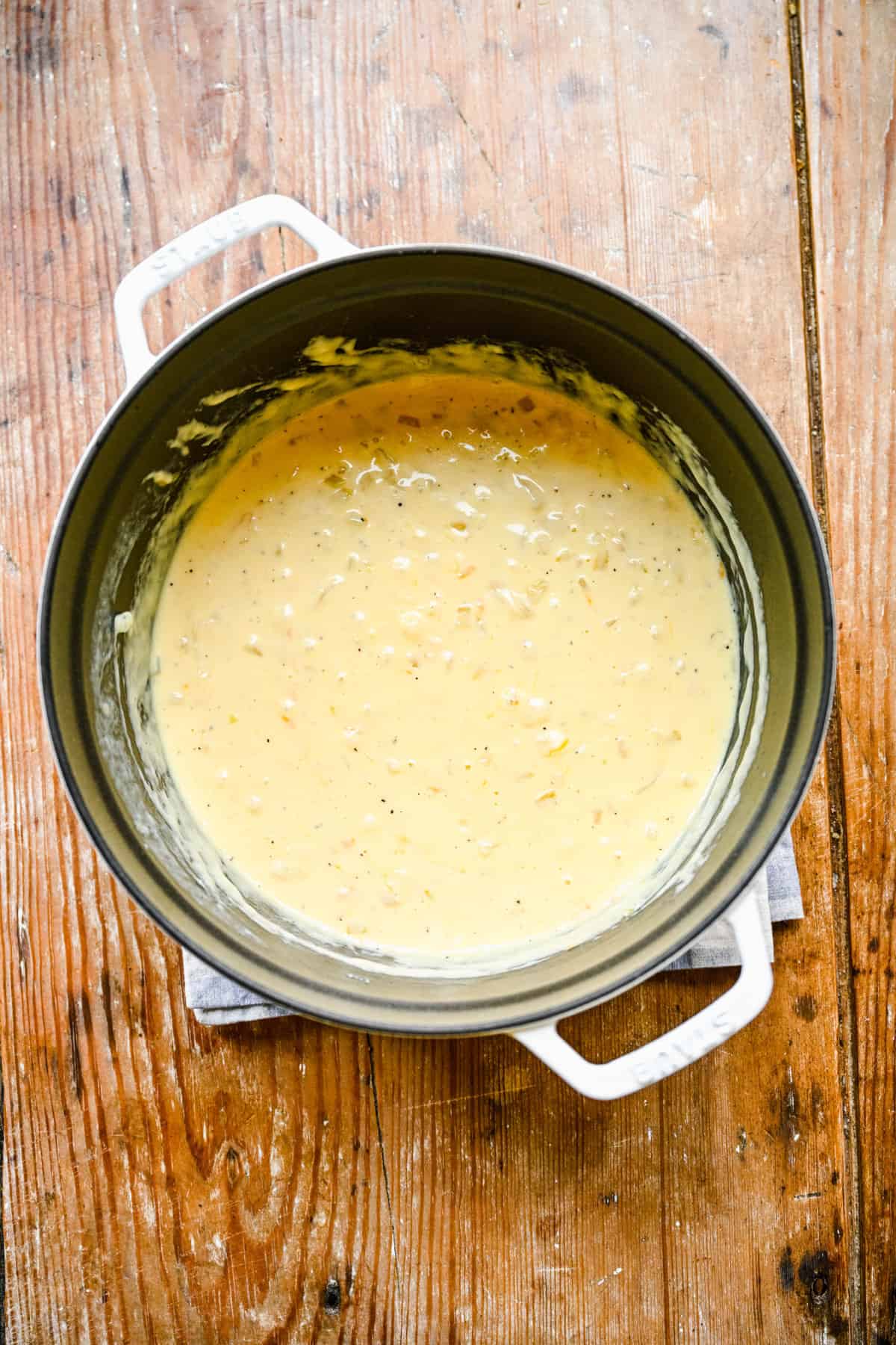 Overhead view of cooked cheese sauce in a large sauce pan.