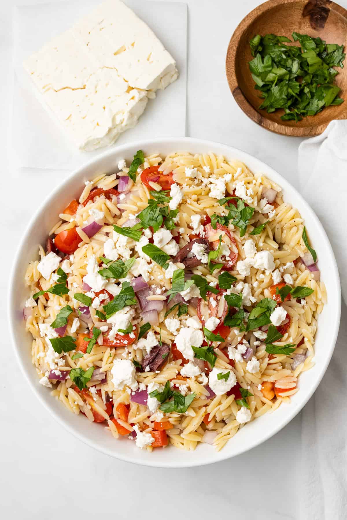 An overhead image of Greek orzo salad ready to be served.
