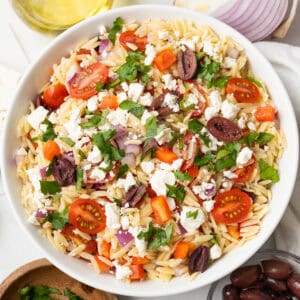 An overhead image of Greek Orzo Salad served in a bowl.