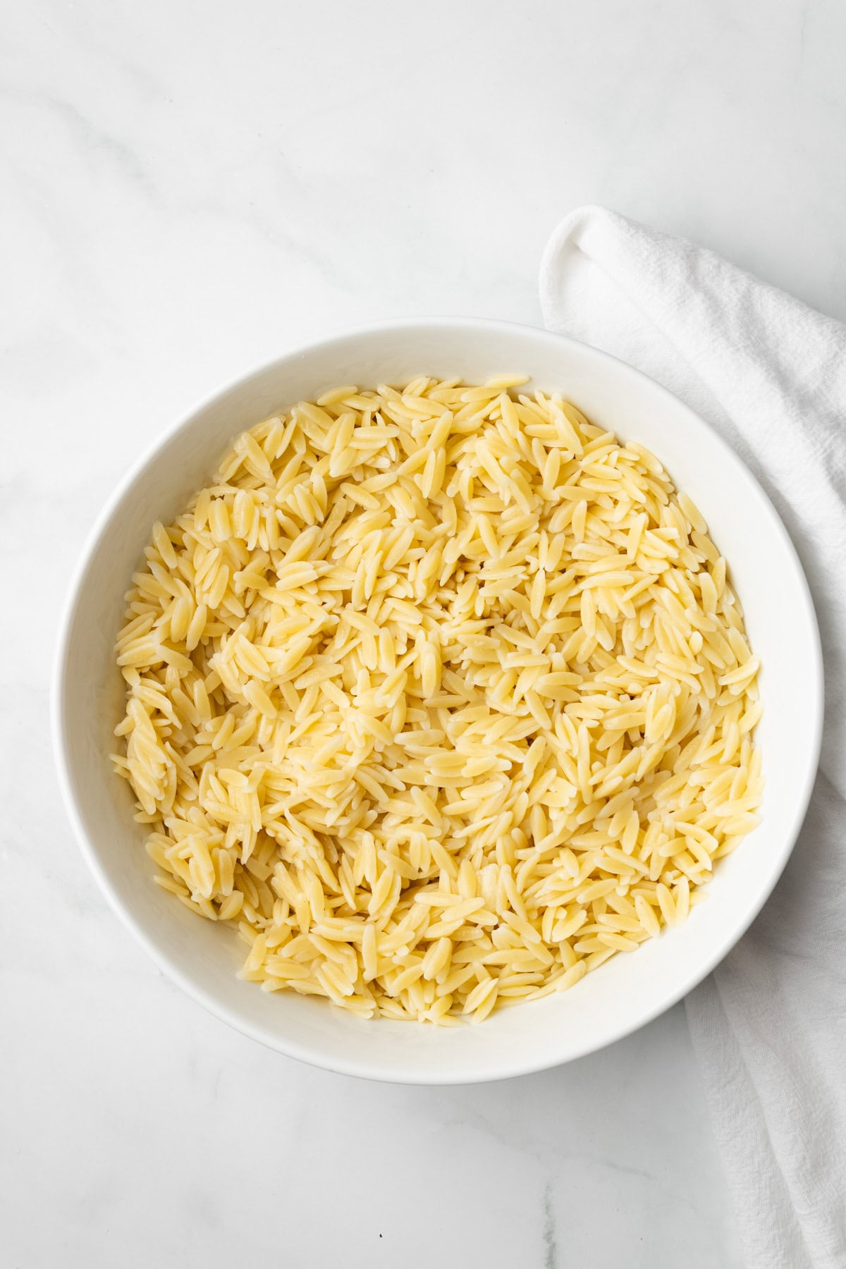 An overhead image of cooked orzo pasta.