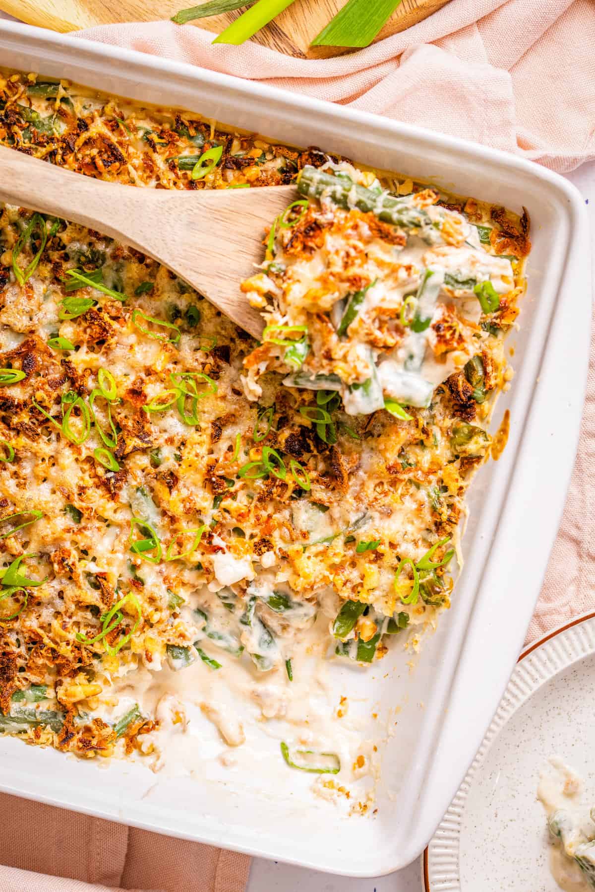 Green bean casserole with cream cheese scooped with spoon