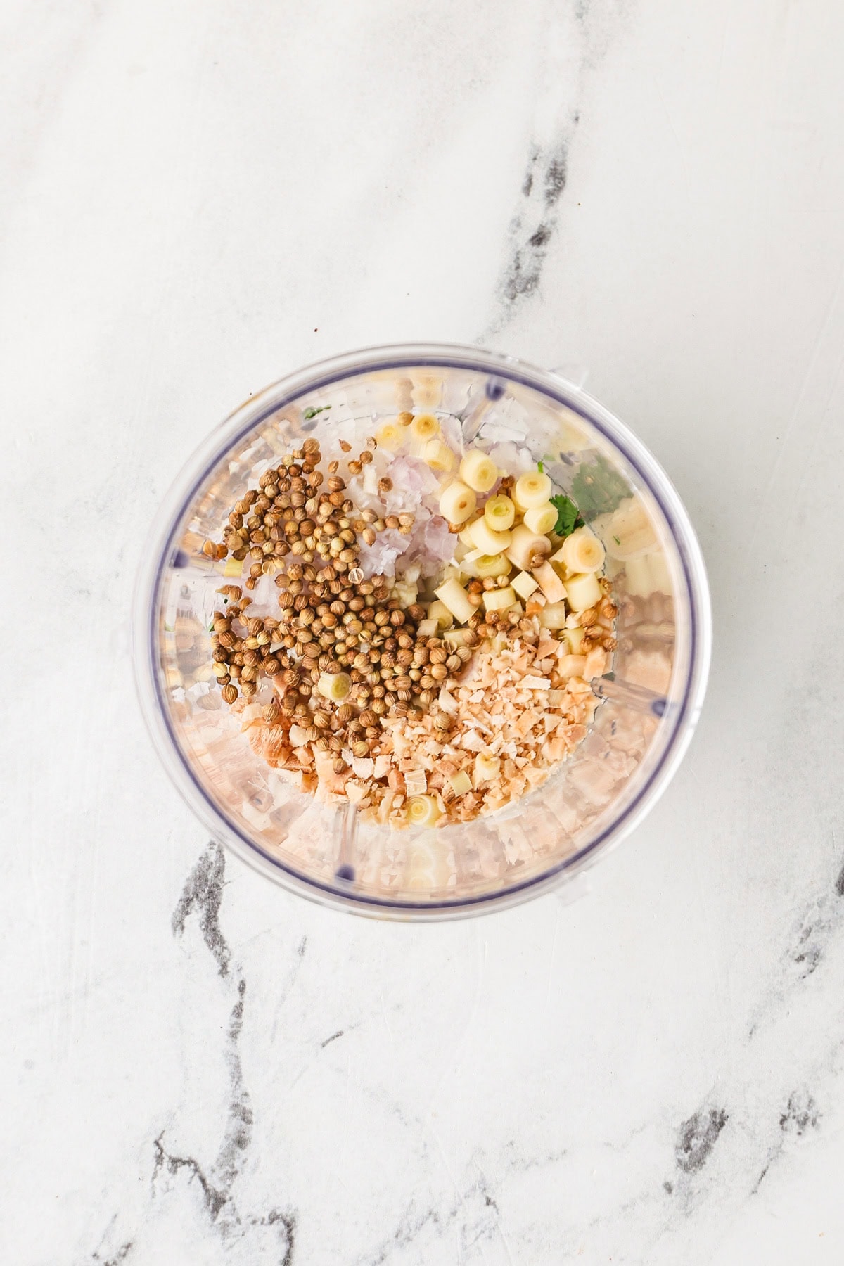Ingredients of Thai green curry paste added in a blender.