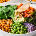 A close up image of chickpea buddha bowl with dressing.