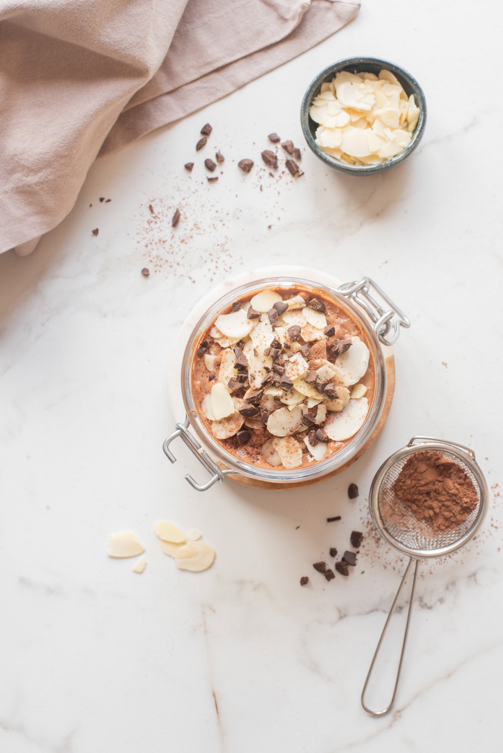 Chocolate hemp power overnight oats with toppings in a jar.
