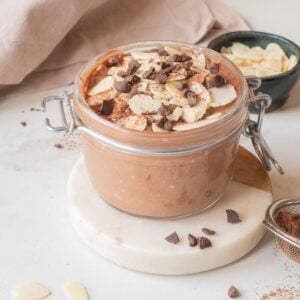 Close-up of chocolate hemp power overnight oats with toppings in a jar.
