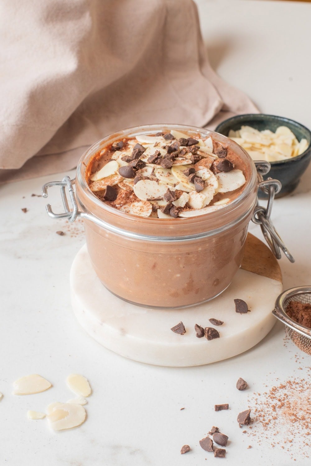 Close-up of chocolate hemp power overnight oats with toppings in a jar.