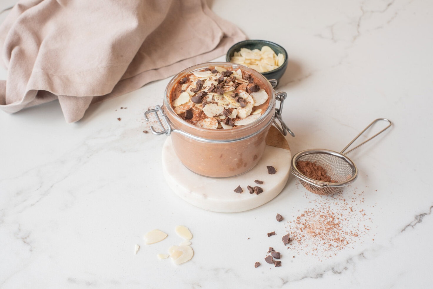 Chocolate hemp power overnight oats with toppings in a jar.