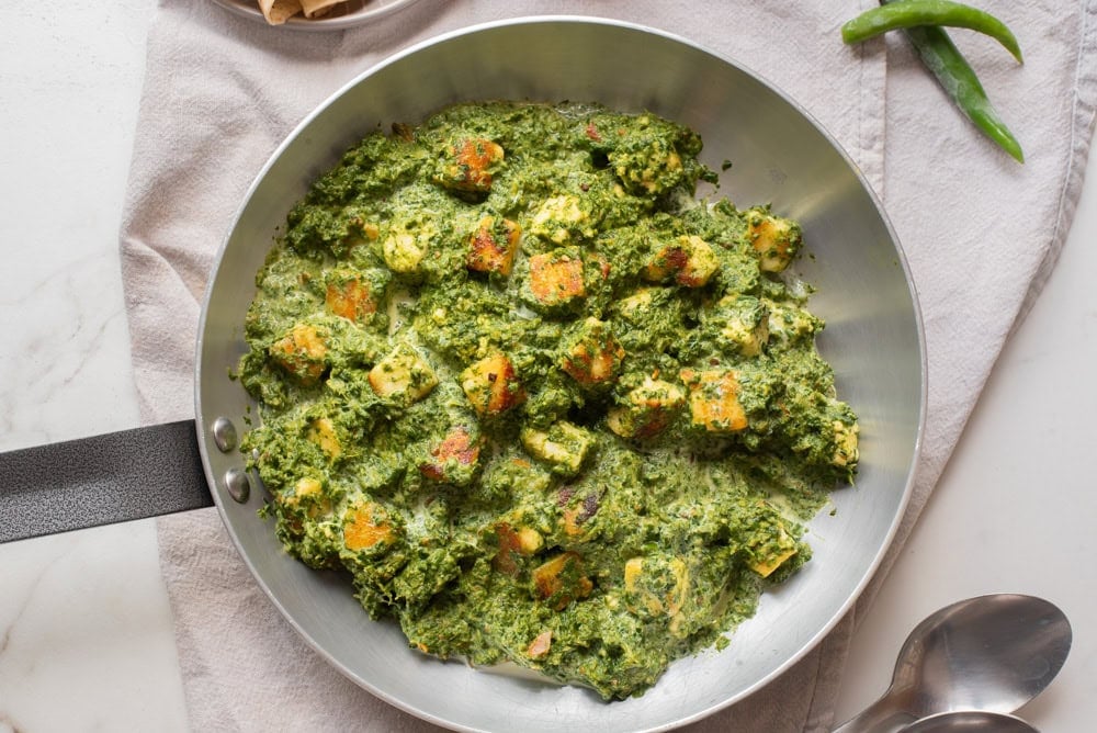 An overhead image of palak paneer in a skillet.