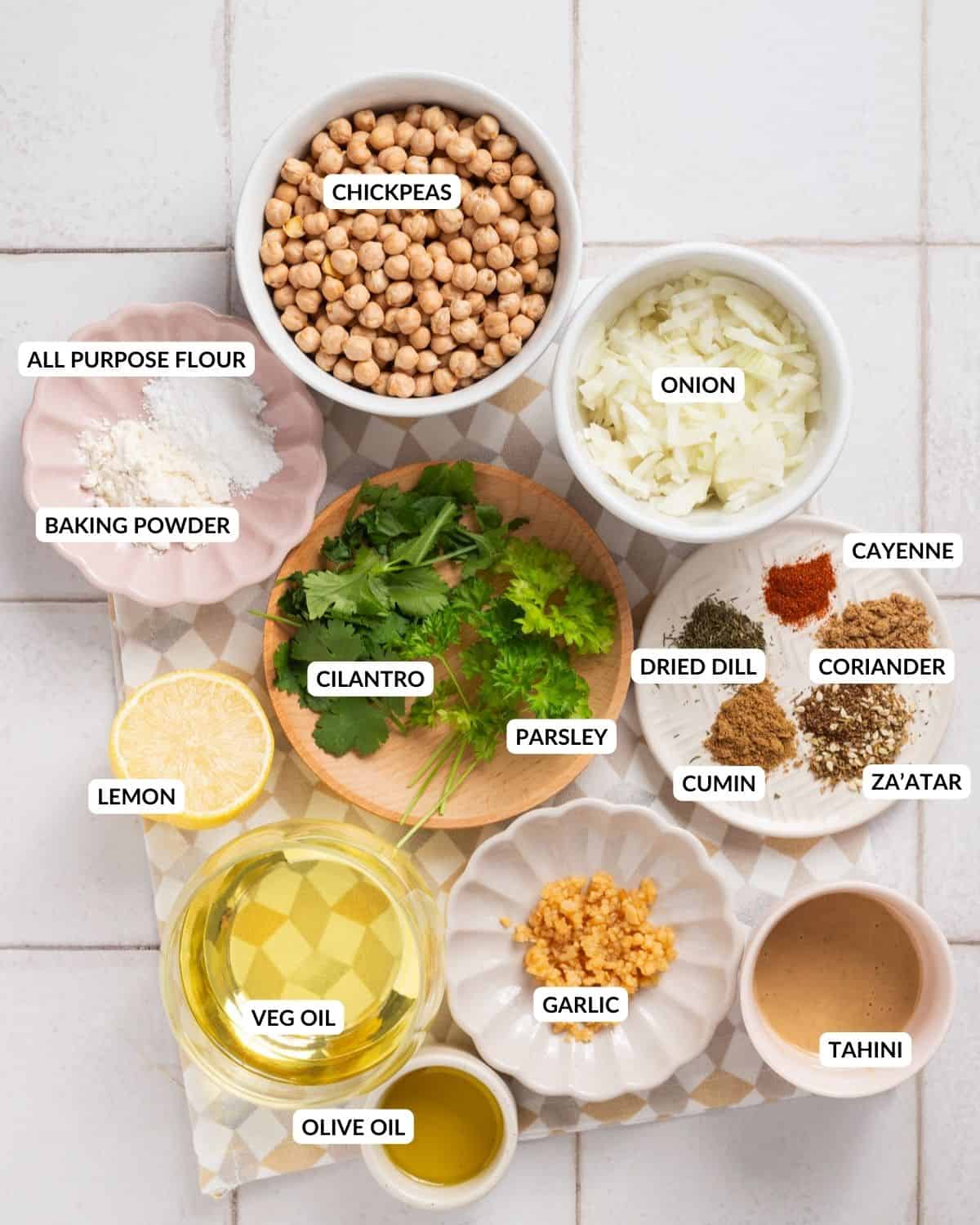 Overhead labeled view of ingredients for hummus and falafel, check recipe card for details. 