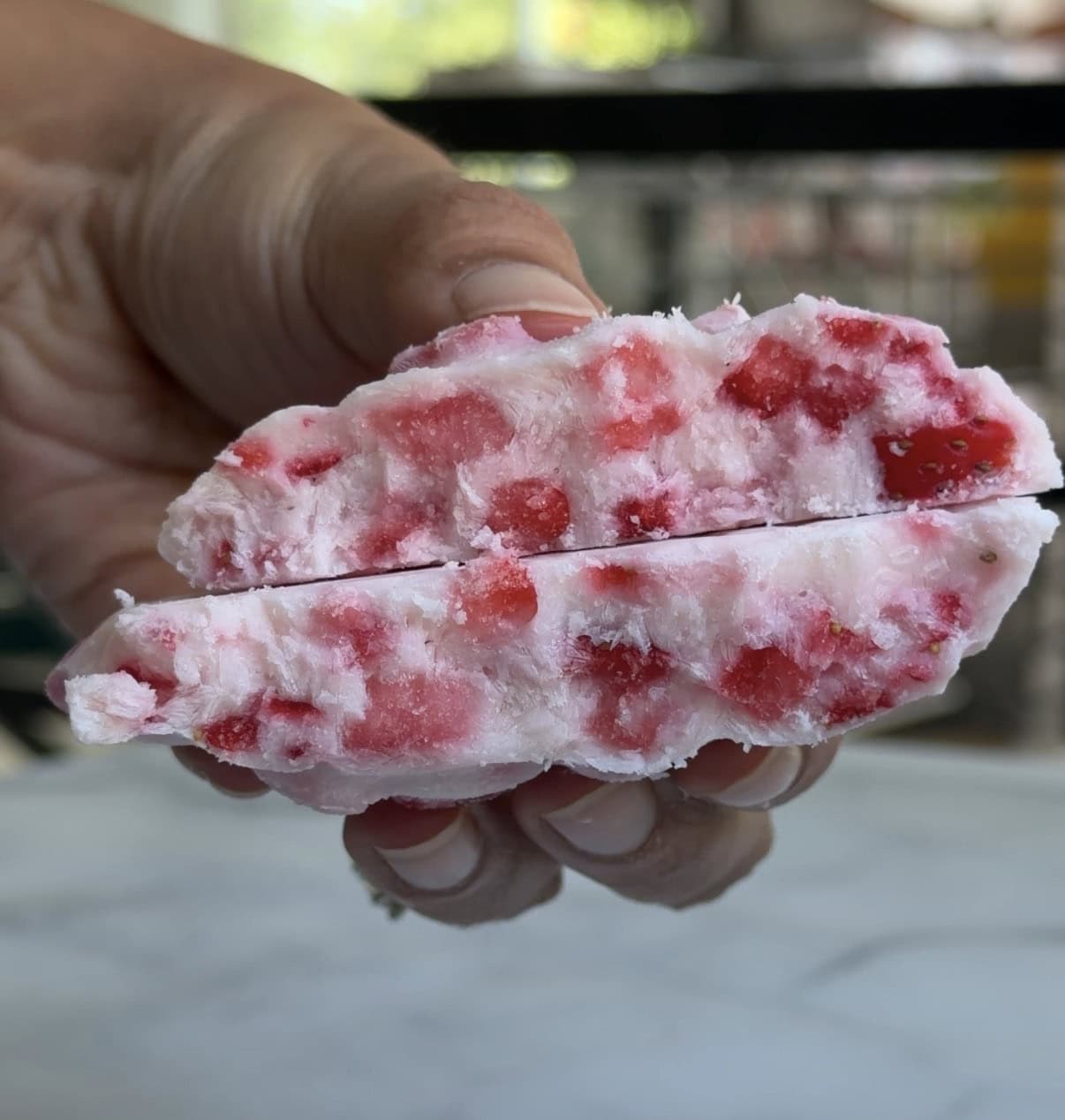 Close up of Shruthi holding clusters without chocolate coating