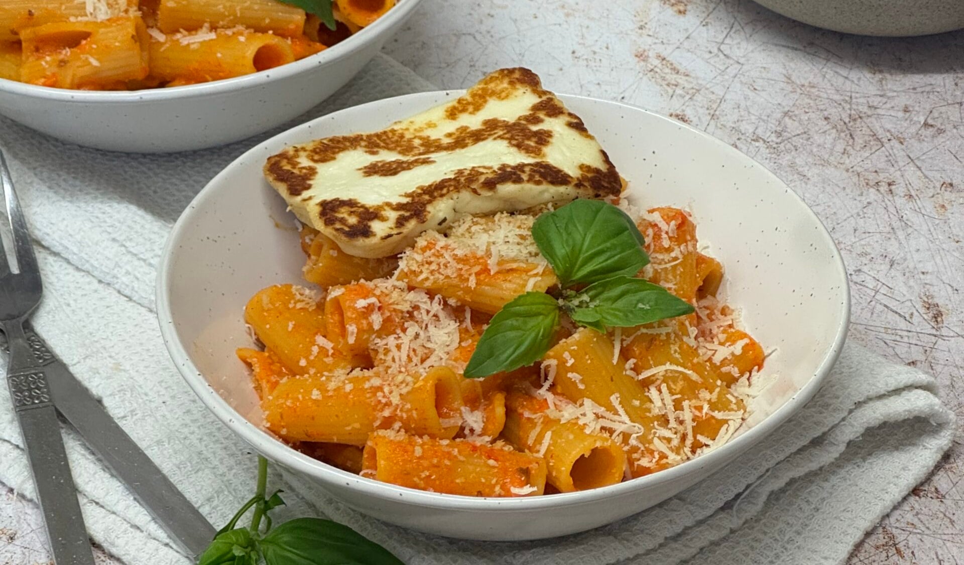 Romesco pasta served with halloumi