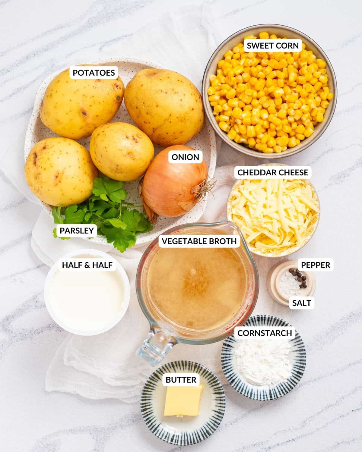 An overhead image of instant pot corn chowder ingredients in separate containers with labels on them.