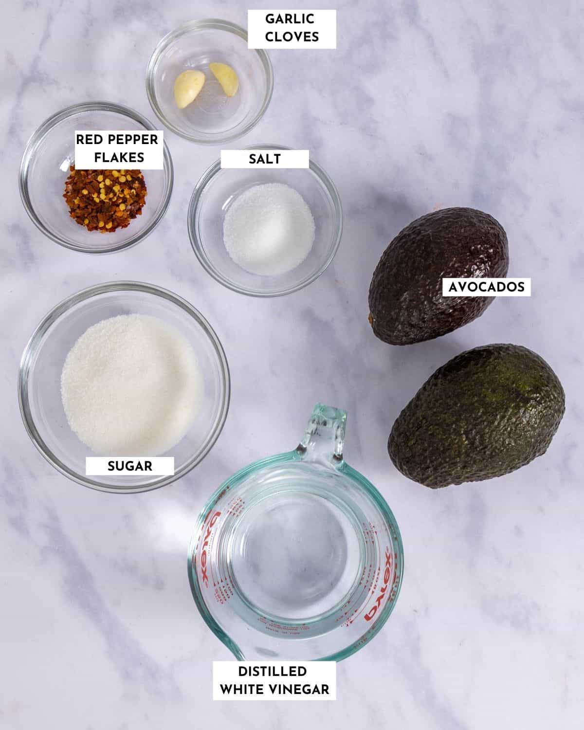 Labeled list of ingredients for making pickled avocados - check recipe card for details!