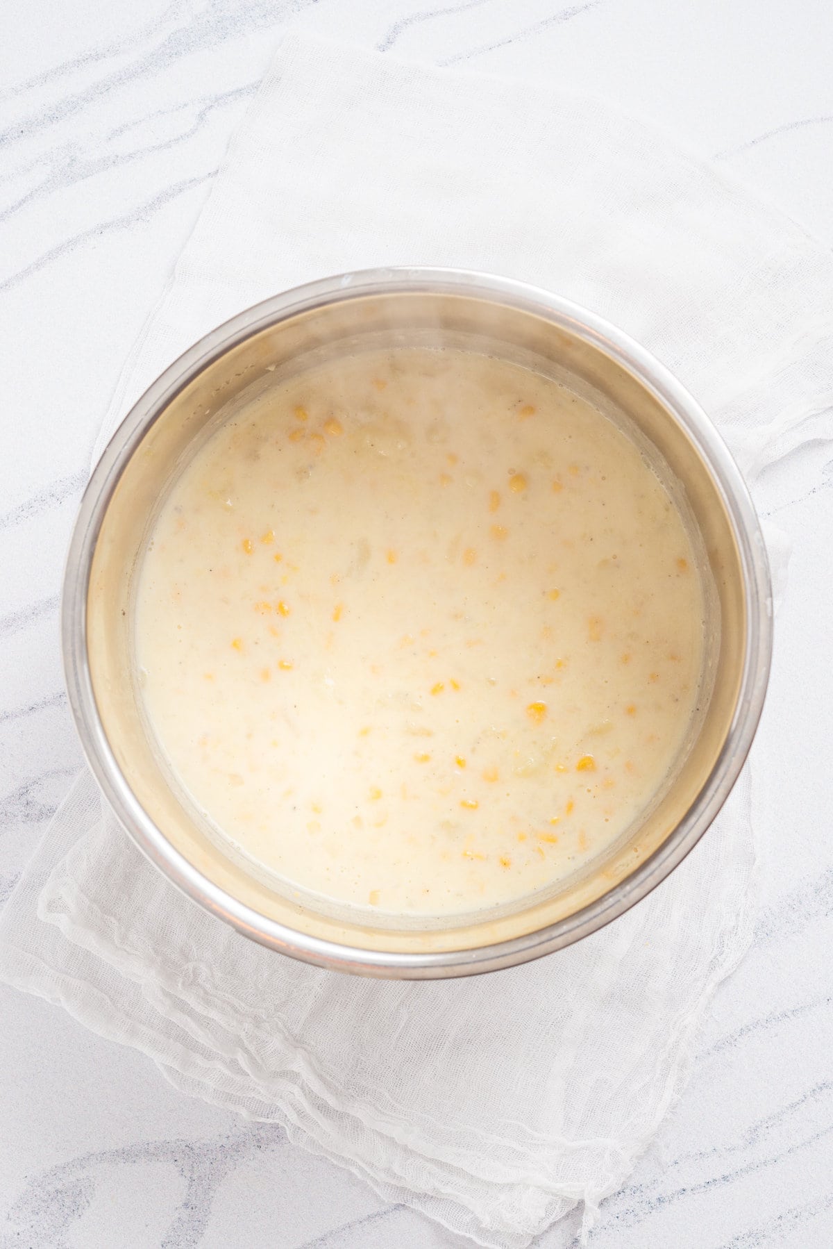 An overhead image of cooked corn chowder in an instant pot.