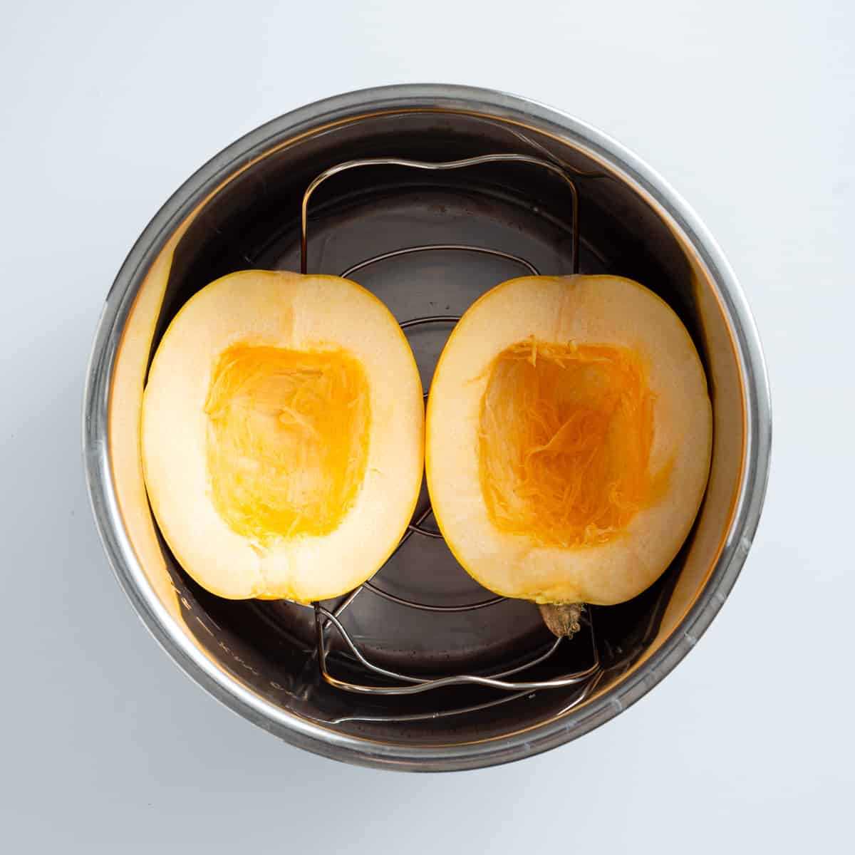 An overhead image of cooked spaghetti squash in an instant pot.