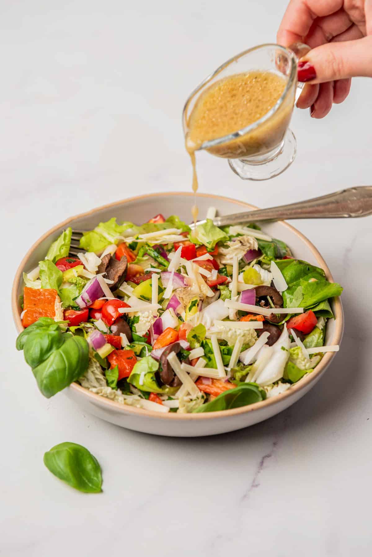 An image of an Italian chopped salad with champagne vinaigrette dressing, in a serving plate.