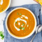 An overhead image of kabocha squash soup served in a bowl.