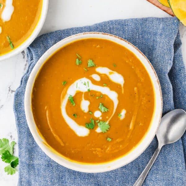 An overhead image of kabocha squash soup served in a bowl.