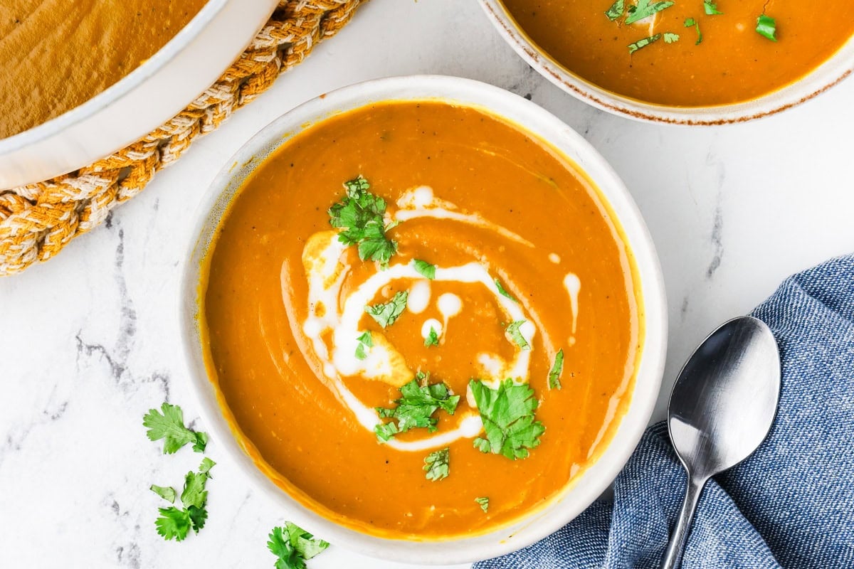 An overhead image of kabocha squash soup served in a bowl.